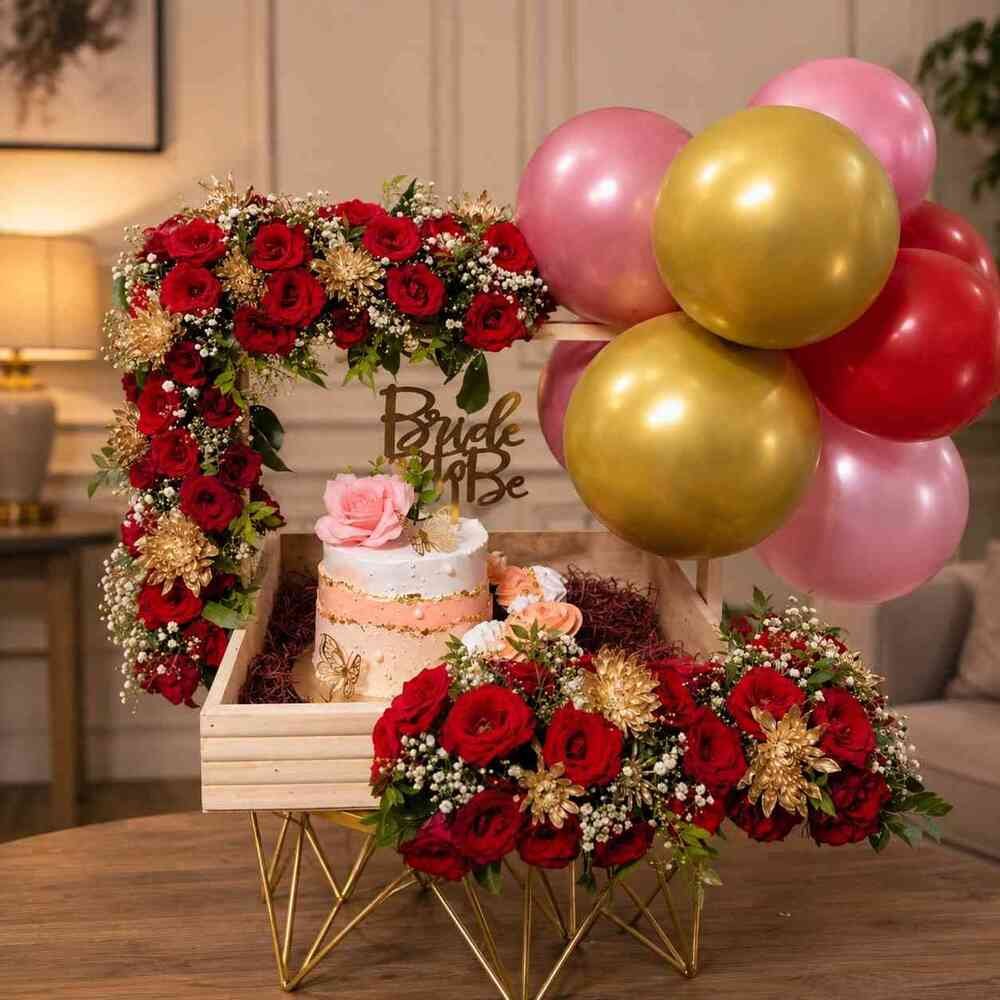 Exquisite bridal shower gifts featuring a cake, roses, and balloons.