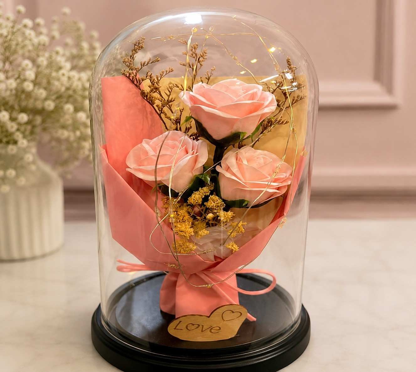 Flower gift Lahore with pink roses inside an elegant glass dome.