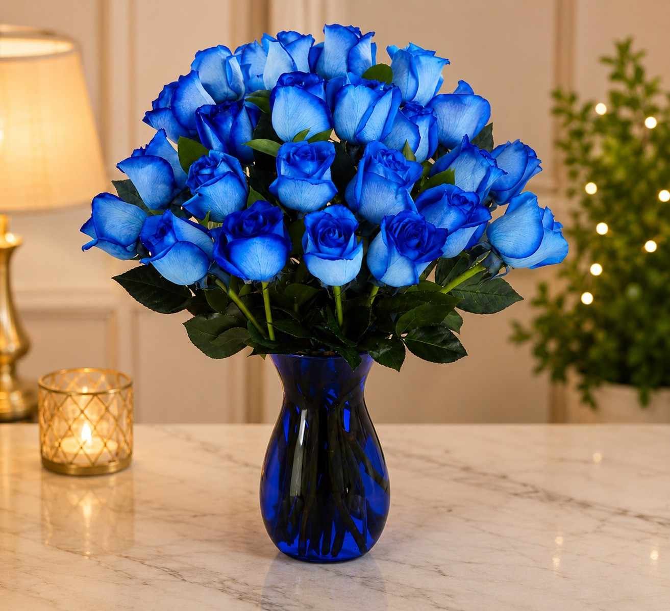 blue rose arrangement in cobalt glass vase