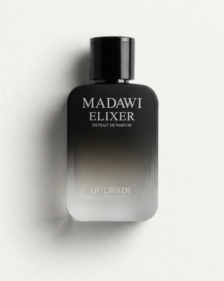 Hands holding a black and silver ombre glass bottle of Madawi Elixer Extrait de Parfum by Gulwadi