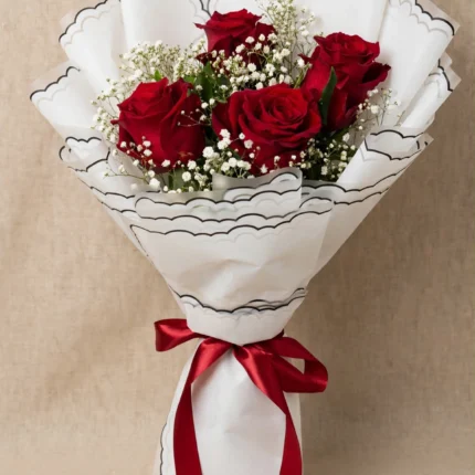 Fresh red rose bouquet with white scalloped wrapping