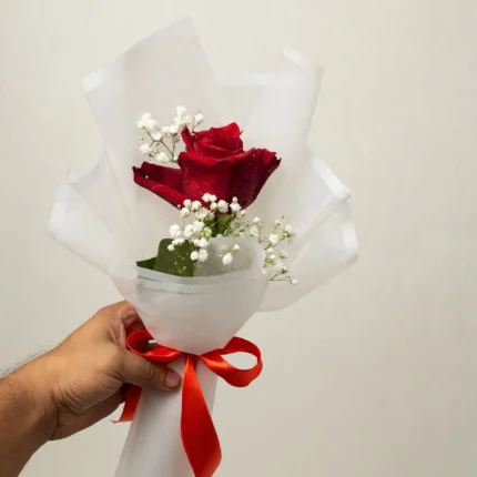 Mini red rose bouquet with baby's breath in white wrapping with red ribbon