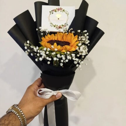 Single fresh sunflower with baby's breath in black wrapping with white ribbon and message card